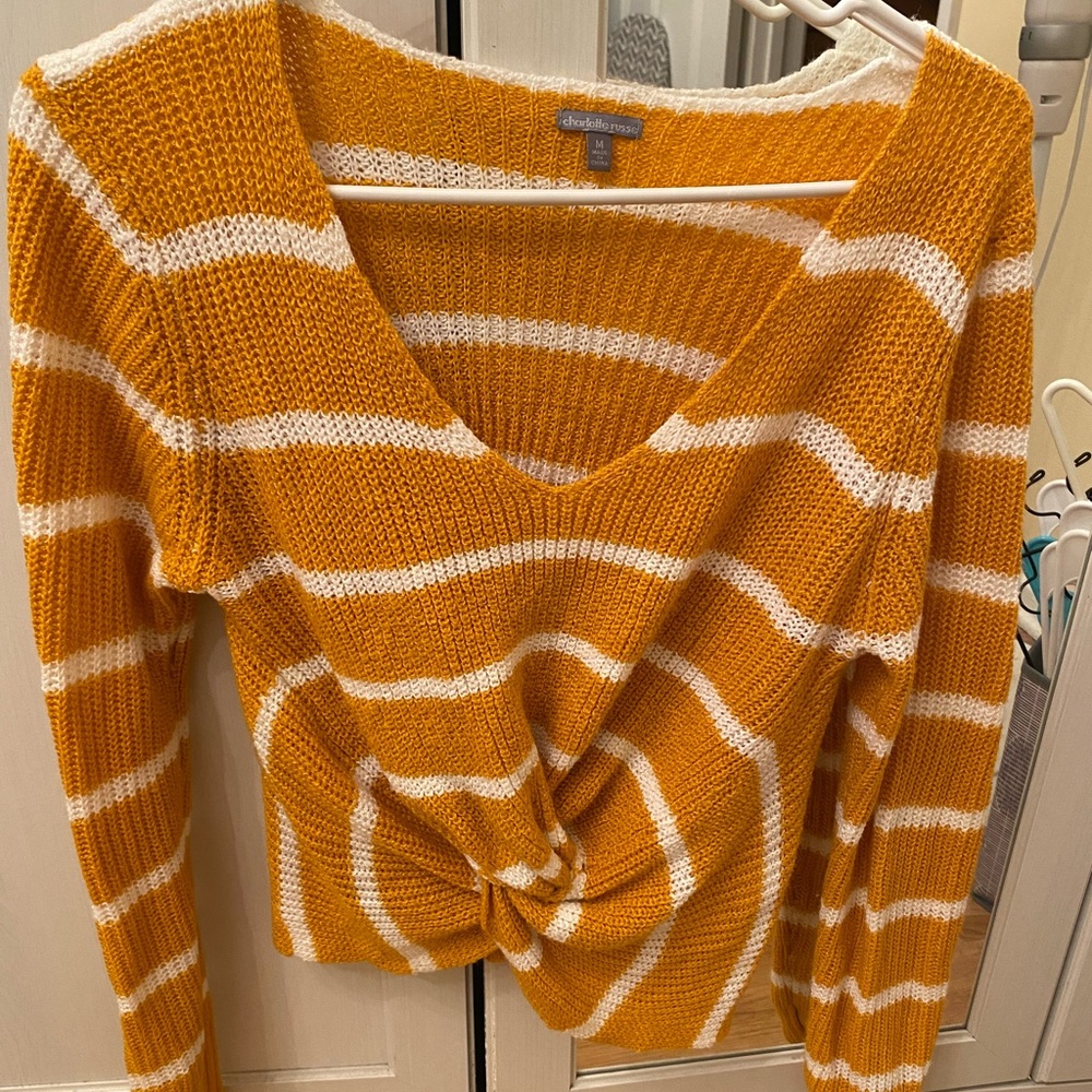 Cropped yellow sweater with white stripes.